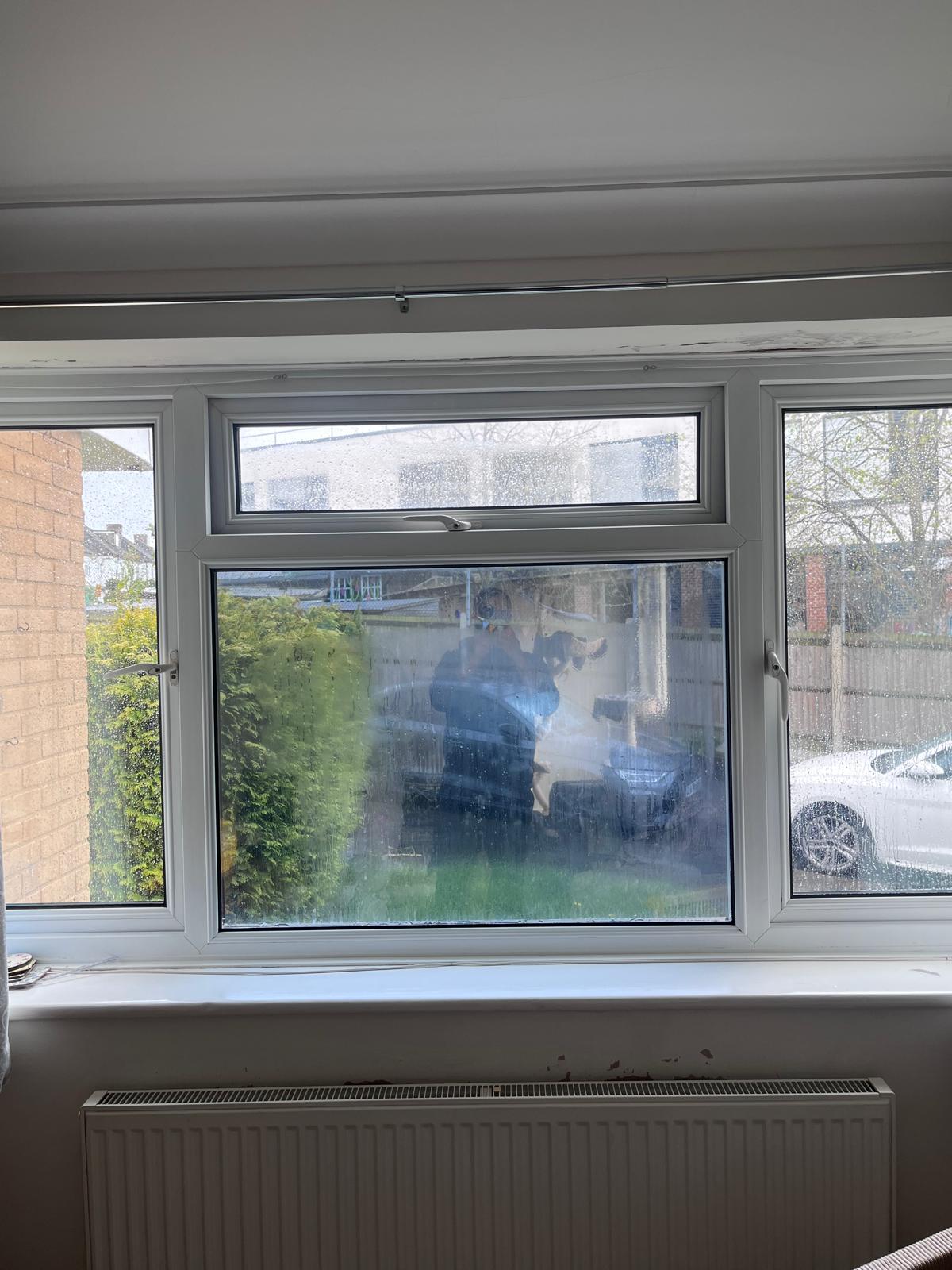 Inside view of a triple window where only the bottom centre panel is tinted