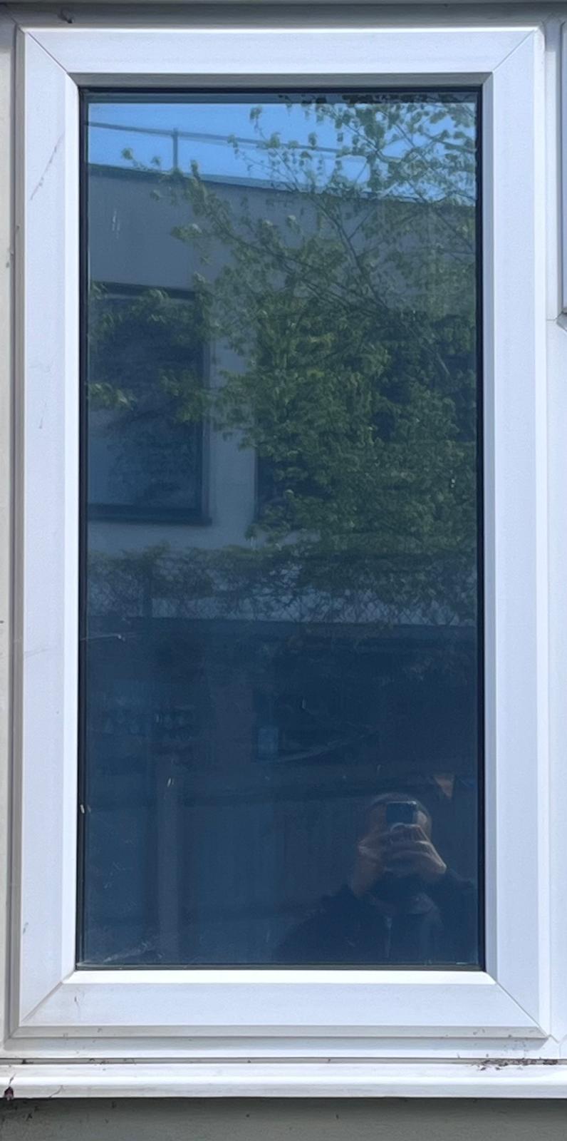 Reflective solar film on a residential window with a mirrored exterior finish